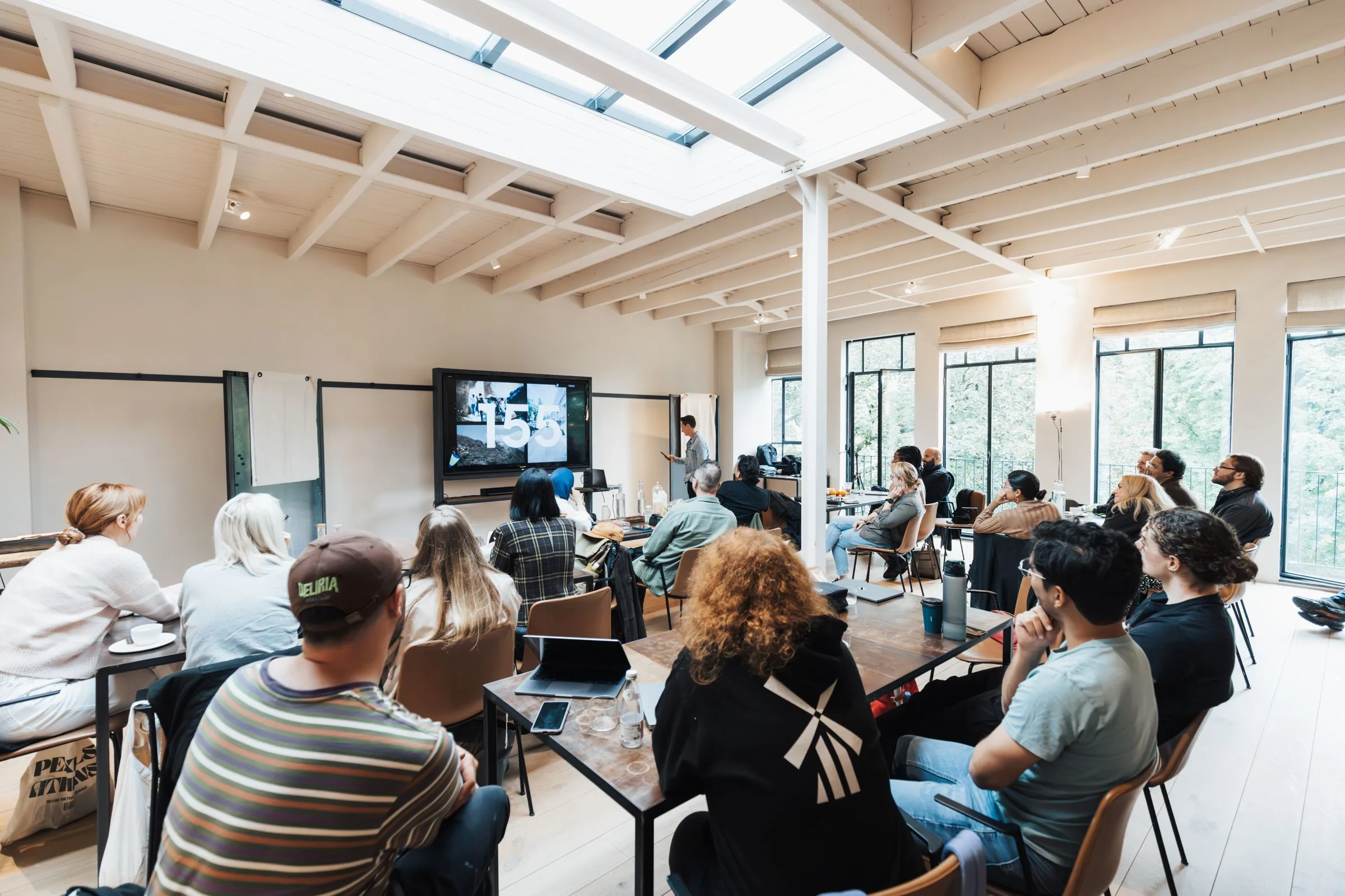 A two-day classroom training: rows of people under a skylight